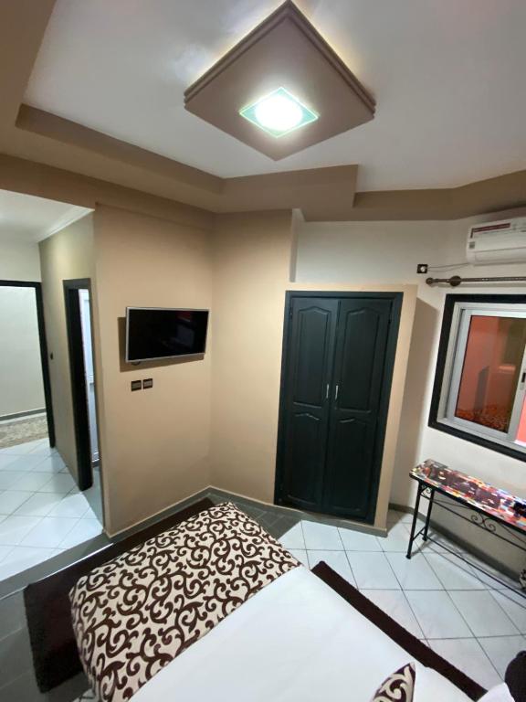 a bedroom with a bed and a tv at Hotel VELSATIS in Beni Mellal