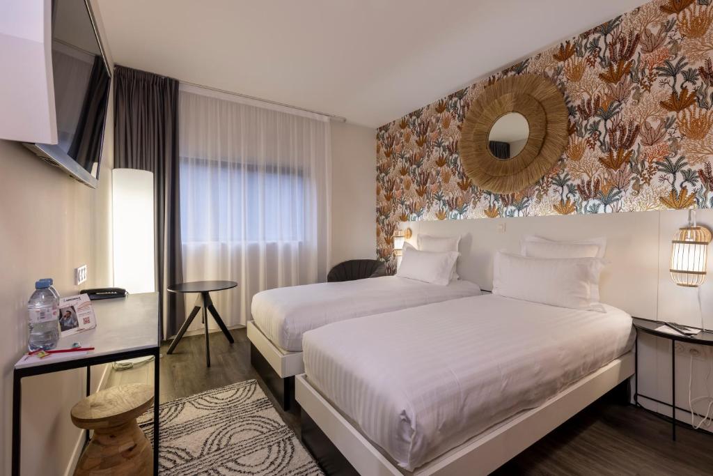 Postel nebo postele na pokoji v ubytování PADJA Hôtel & Spa Vannes