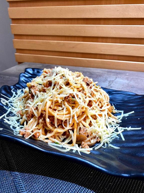a pile of cheese on a blue plate on a table at Hotel VELSATIS in Beni Mellal