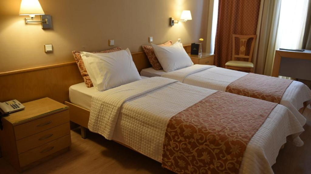 Postel nebo postele na pokoji v ubytování Hotel Xanthippion