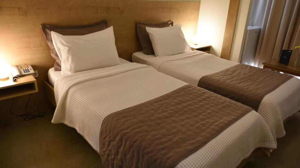 Postel nebo postele na pokoji v ubytování Hotel Xanthippion