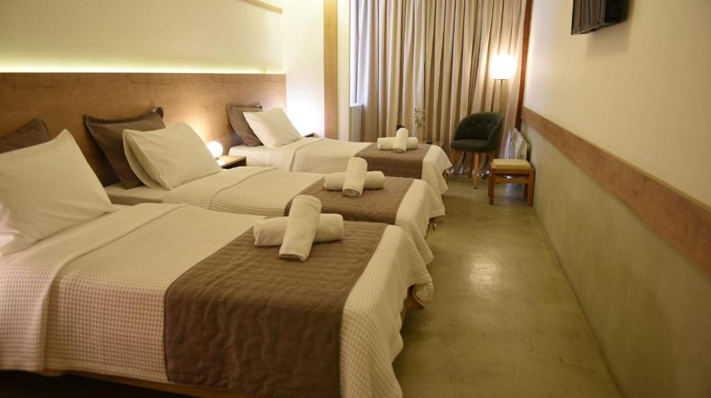 Postel nebo postele na pokoji v ubytování Hotel Xanthippion
