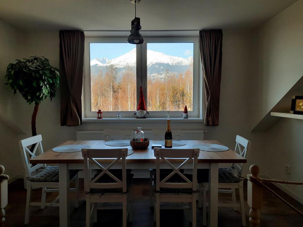 een eettafel met uitzicht op een berg bij Apartment 55 Tatry in Veľký Slavkov