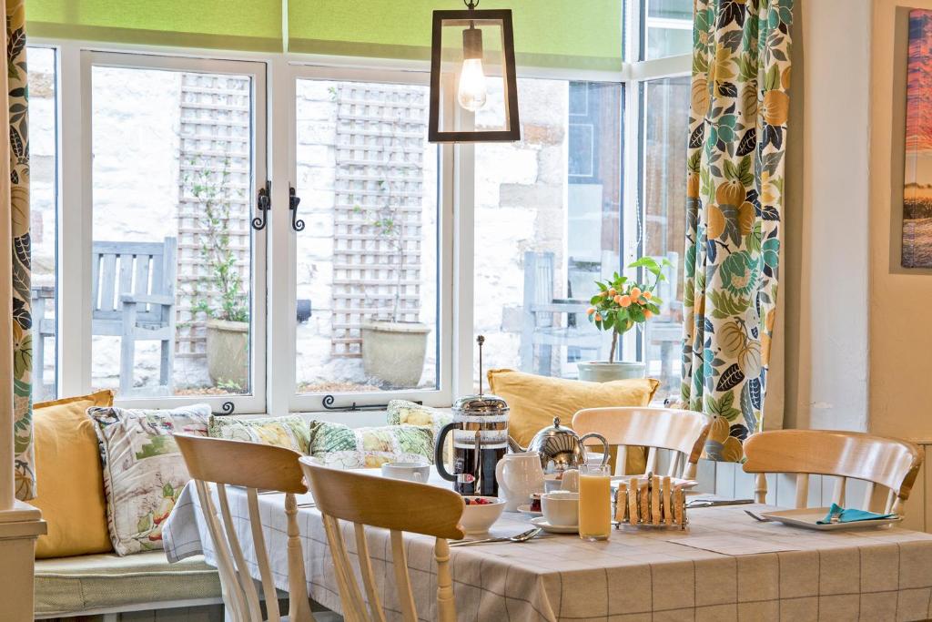 a dining room with a table and chairs at Hawthorn Farm Guest House in Buxton
