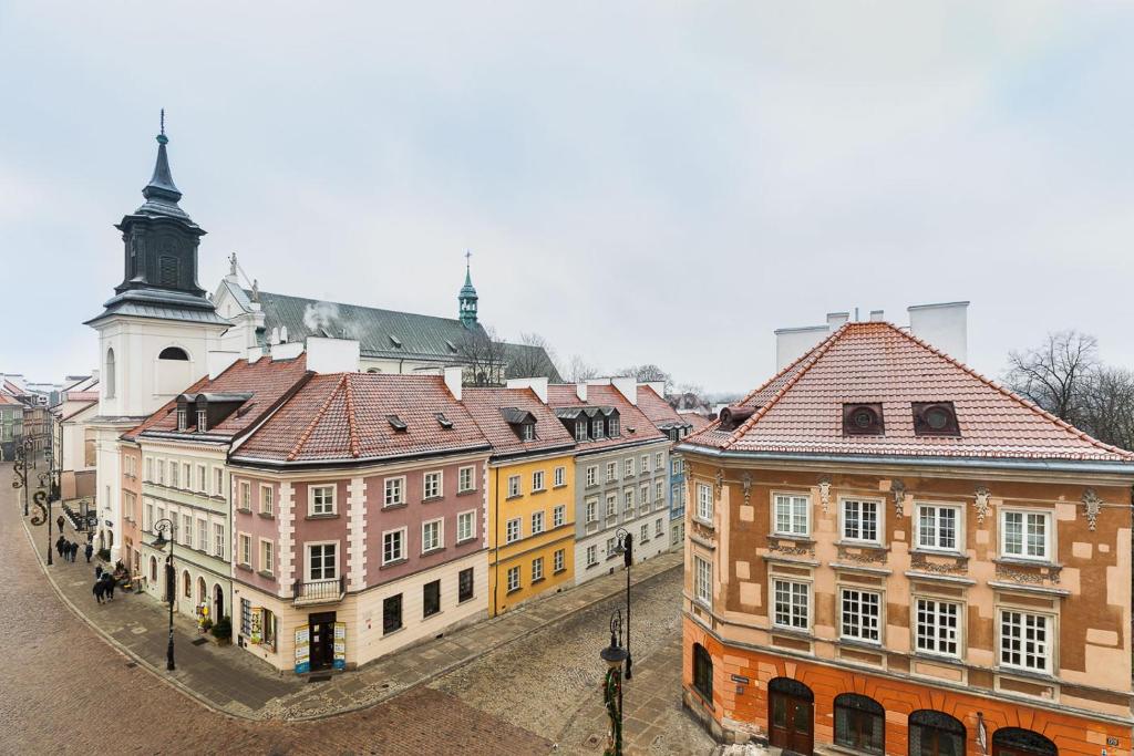 a group of buildings in a city with a clock tower at P&O Serviced Apartments Old Town Podwale in Warsaw