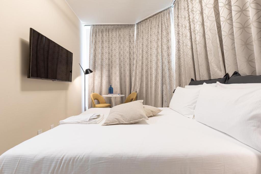 A bed or beds in a room at BePlace Apartments in Duomo