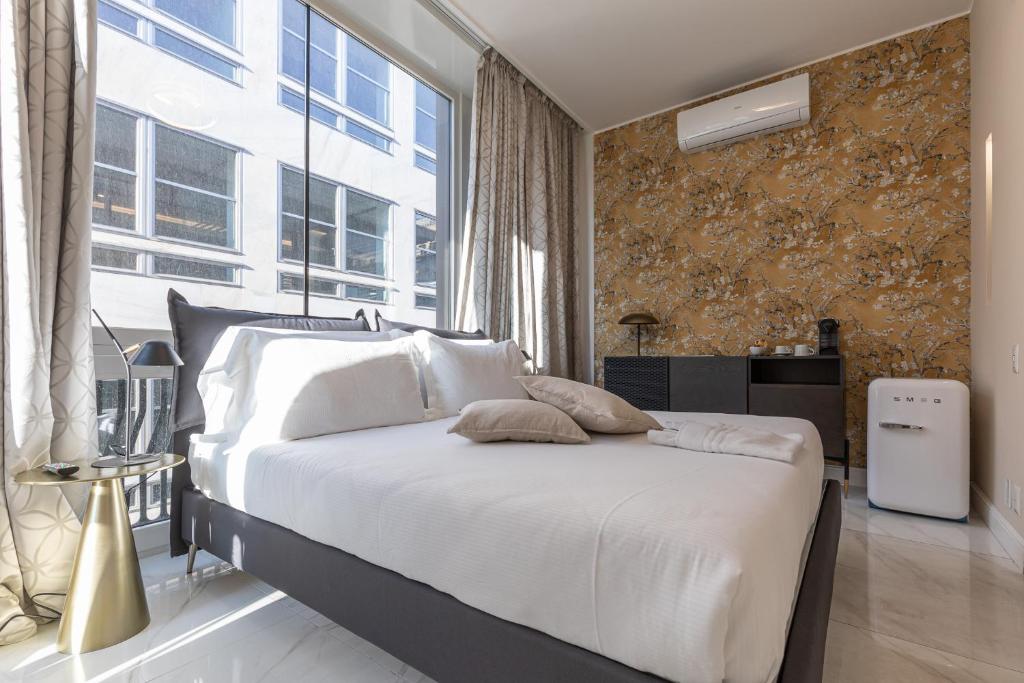 A bed or beds in a room at BePlace Apartments in Duomo