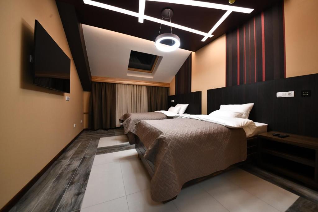 Postel nebo postele na pokoji v ubytování Hotel Havana Loznica