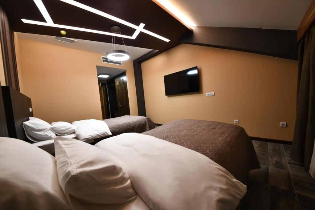 Postel nebo postele na pokoji v ubytování Hotel Havana Loznica