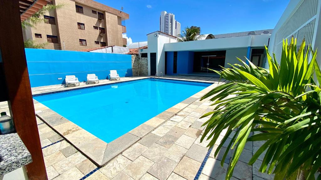 a swimming pool in the backyard of a house at Casa agradável com excelente piscina para toda a família in João Pessoa