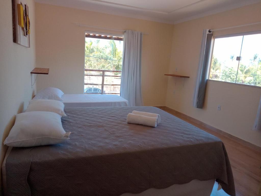 En eller flere senge i et værelse på Pousada Nobre