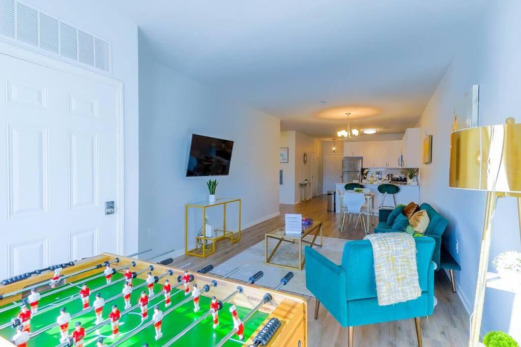 a living room with a pool table in the middle at *King Bed Ideal For Long Stays w/ Foosball Table!* in Carteret