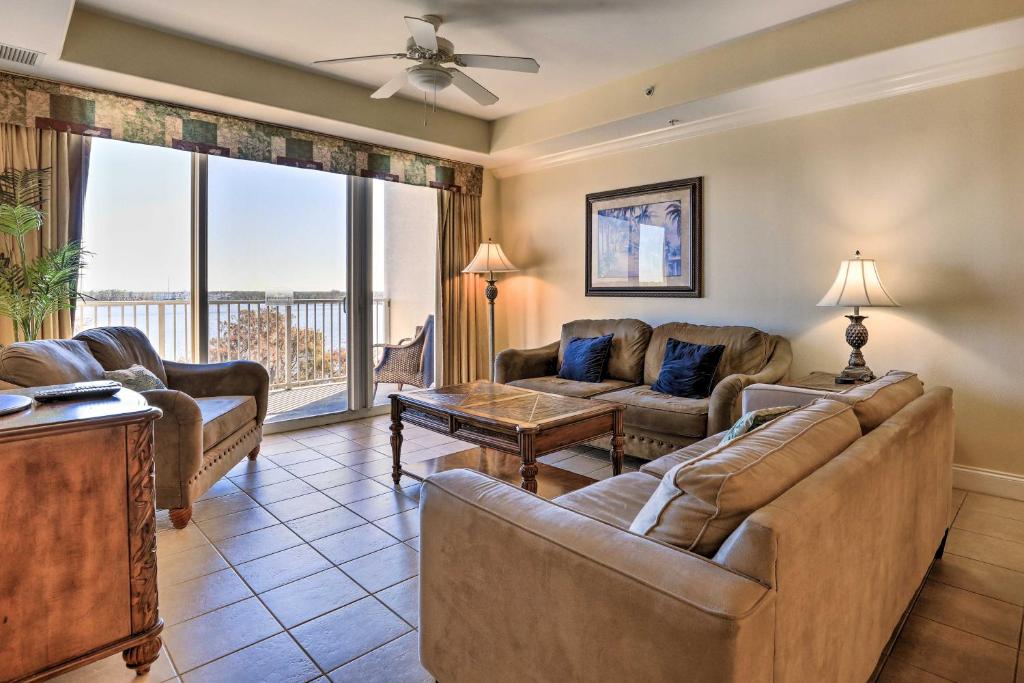 a living room with couches and a table at Orlando Condo with Pool about 1 Mi to Disney! in Orlando