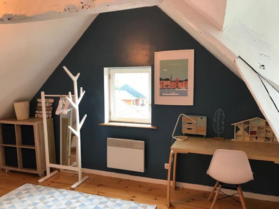 a room with a desk in a attic at La Closerie un écrin de verdure à 500m de la plage in Sainte-Adresse
