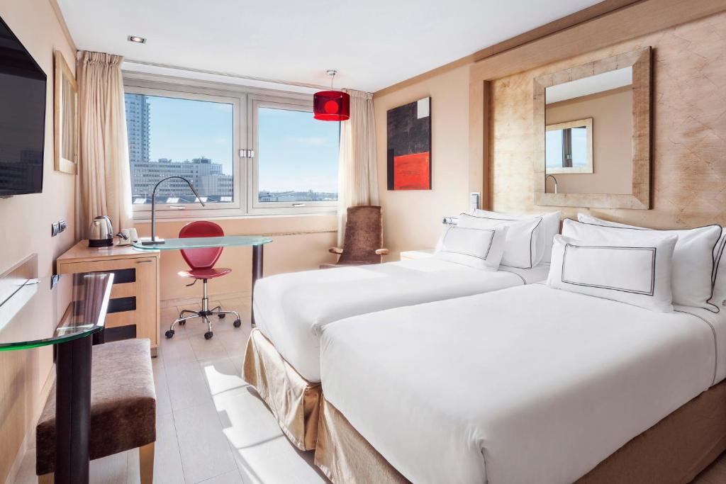 A bed or beds in a room at Melia Madrid Princesa