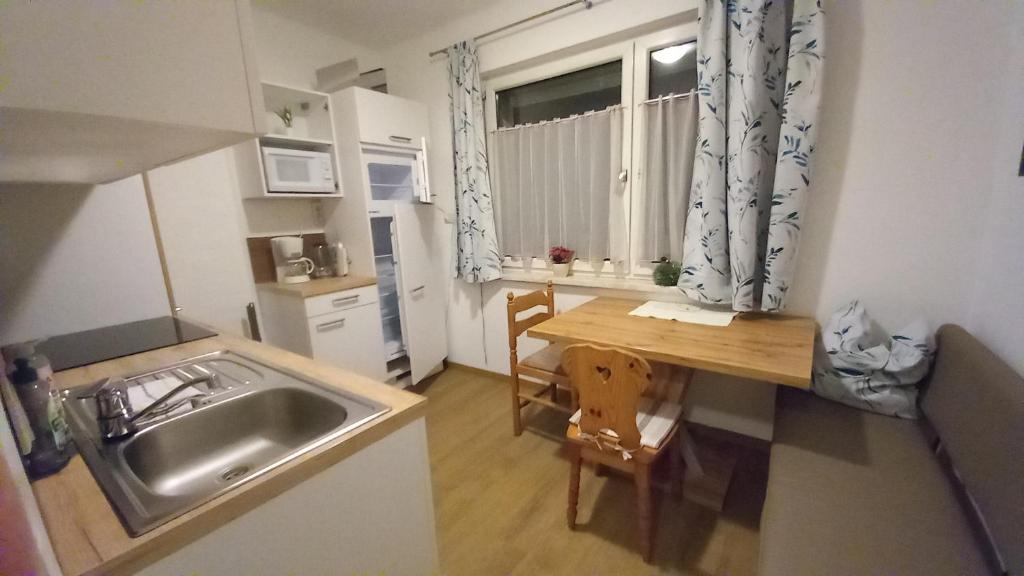 a small kitchen with a sink and a table at Appartement Sonnenschein in Schladming