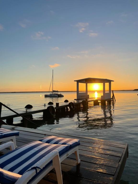 boats are docked at a pier with a view of the ocean at Hotel Aldea 19 Bacalar in Bacalar