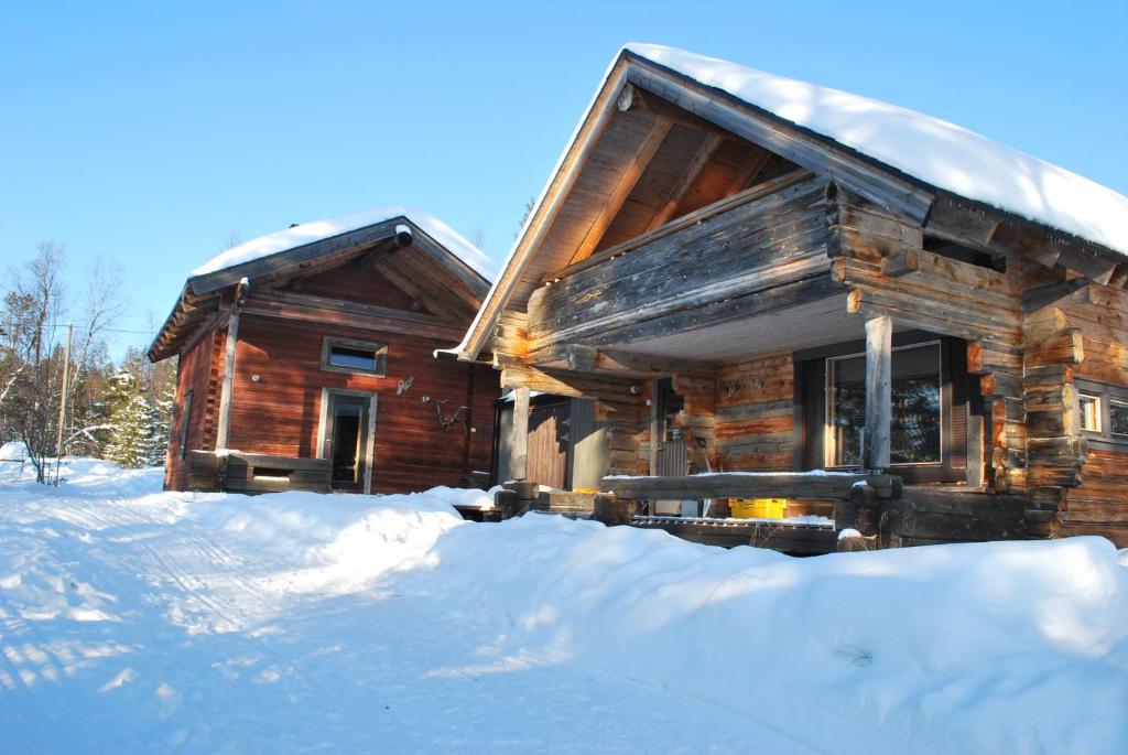 a log cabin with snow in front of it at Loma-asunto tunturimaisemassa in Ylikyro