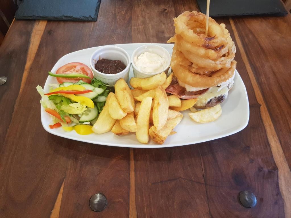 a plate of food with a sandwich and french fries at Albion Guest House & Apartments in Pembroke Dock