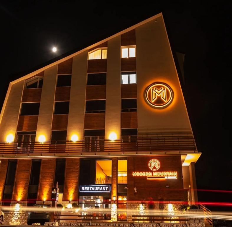 a building with a volkswagen sign on it at night at Modern Mountain Apartman 202 in Kolašin