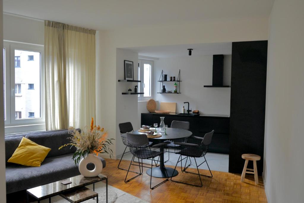 a living room with a couch and a table at De Flat - Licht en luxueus appartement bij Het Zuid in Antwerp