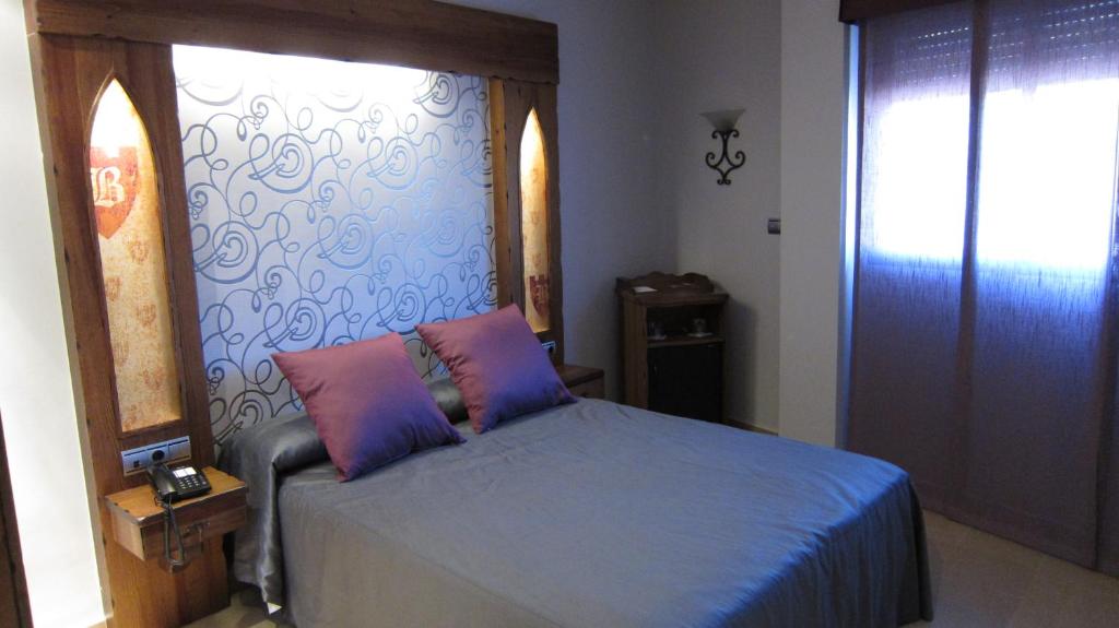 Postel nebo postele na pokoji v ubytování Hotel La Brasa