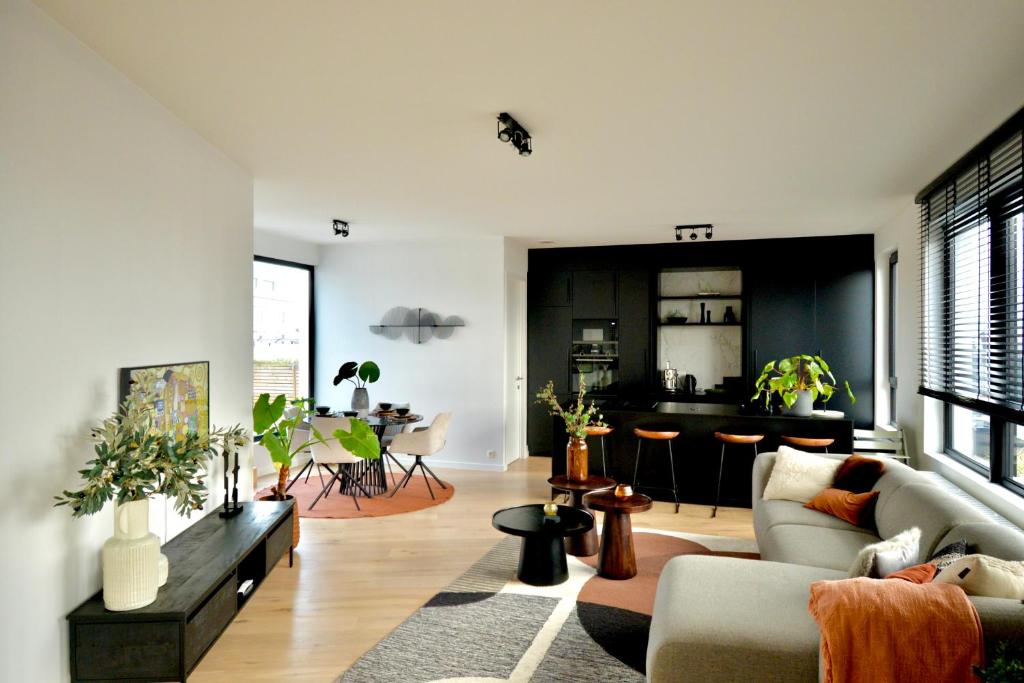 a living room with a couch and a table at The Penthouse, oasis of light and inspiration in Antwerp