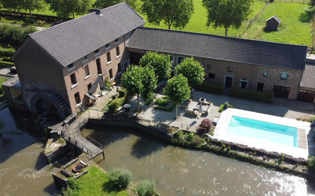 an aerial view of a building with a swimming pool at De Ruttermolen in Tongeren