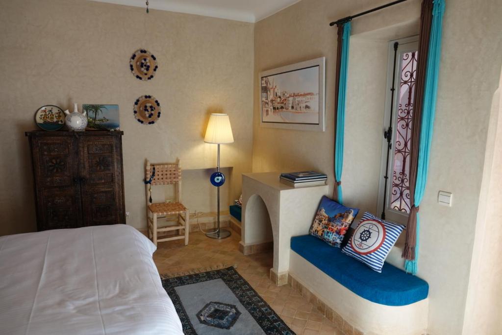 Postel nebo postele na pokoji v ubytování L’oasis de kima