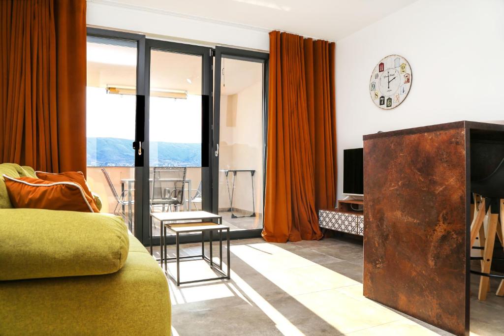 salon z kanapą i zegarem na ścianie w obiekcie Villa Kajgo-Pag w mieście Pag