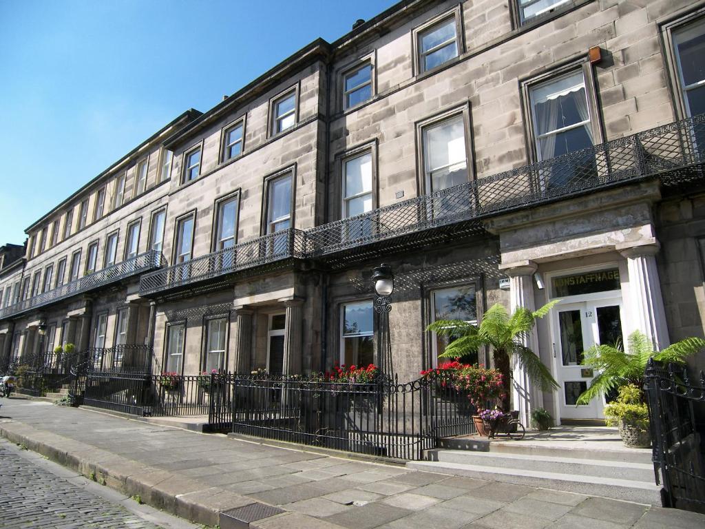 a building with balconies and flowers on a street at Regent Terrace, Central and Charming, Quiet in Edinburgh