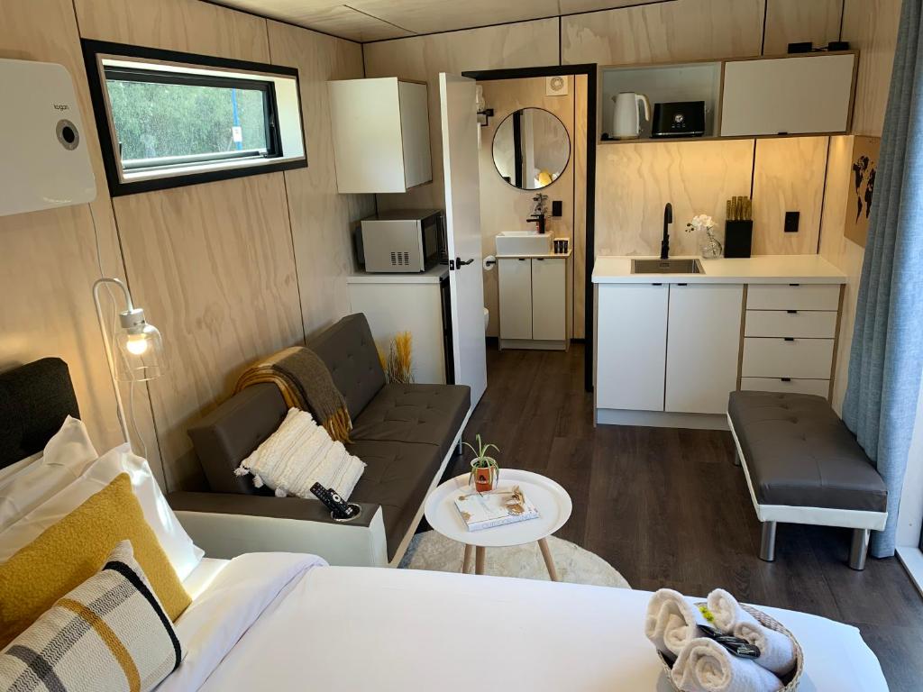 Habitación pequeña con cama y cocina en Snowman Cabins, en Ohakune