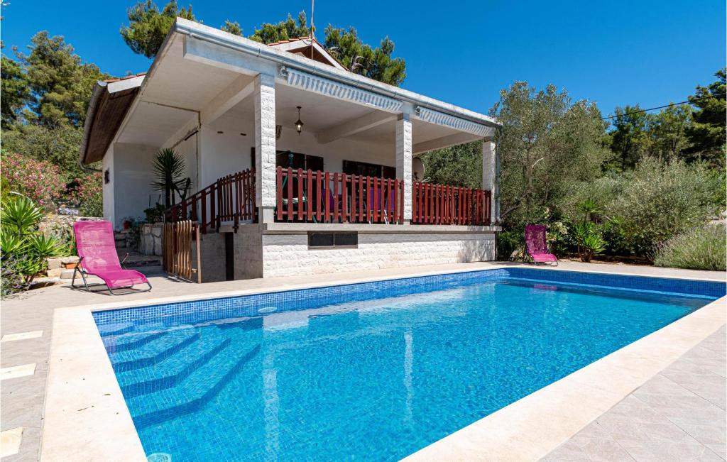 a swimming pool in front of a house at Stunning Home In Vela Luka With Outdoor Swimming Pool in Vela Luka