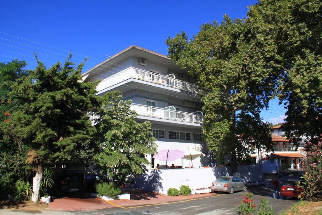 a building with a balcony on the side of it at Galanis Studios and Apartments in Platamonas