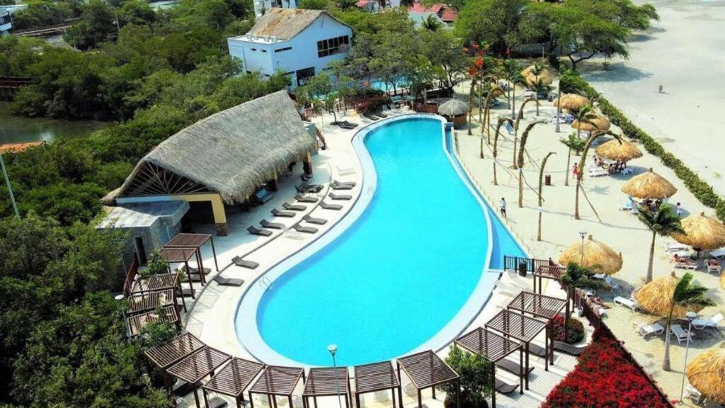 an overhead view of a swimming pool at a resort at Apartamento en Samaria Club de Playa Privada Salida Directa al Mar en Pozos Colorados cerca a Zazue, Estelar, Playa Bello Horizonte, Cabo Tortuga #1 in Santa Marta
