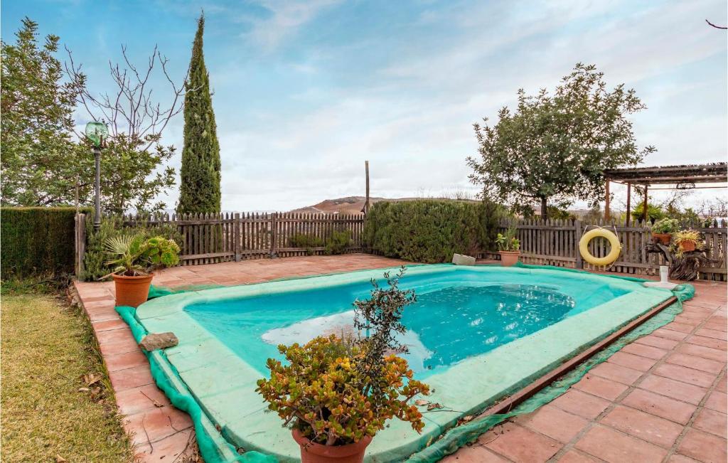 a swimming pool in a yard with a fence at 2 Bedroom Nice Home In Antequera in Antequera