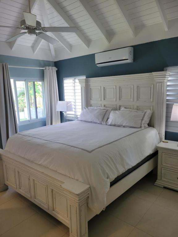 1 dormitorio con cama blanca y pared azul en Breathtaking Villa At The Crest, en Richmond