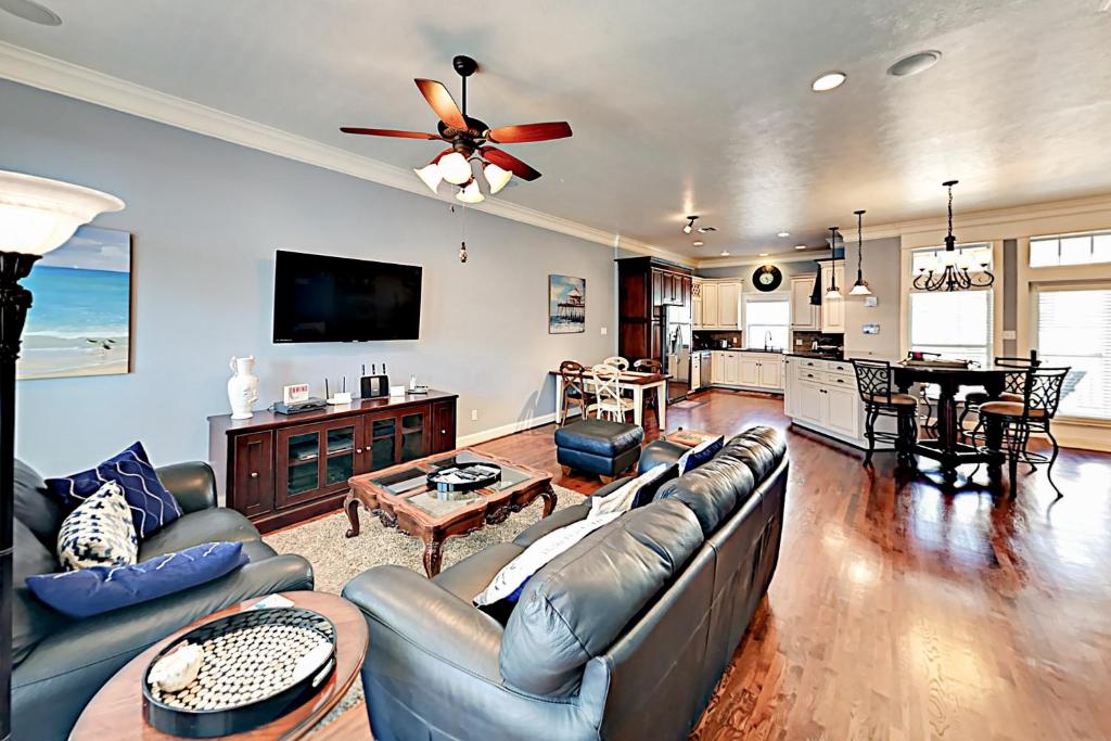 a living room with a couch and a table at Cottage House #103 in Corpus Christi