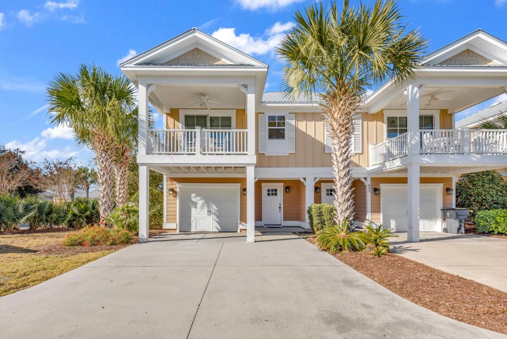 a large house with palm trees in front of it at Madiera Magic in Myrtle Beach