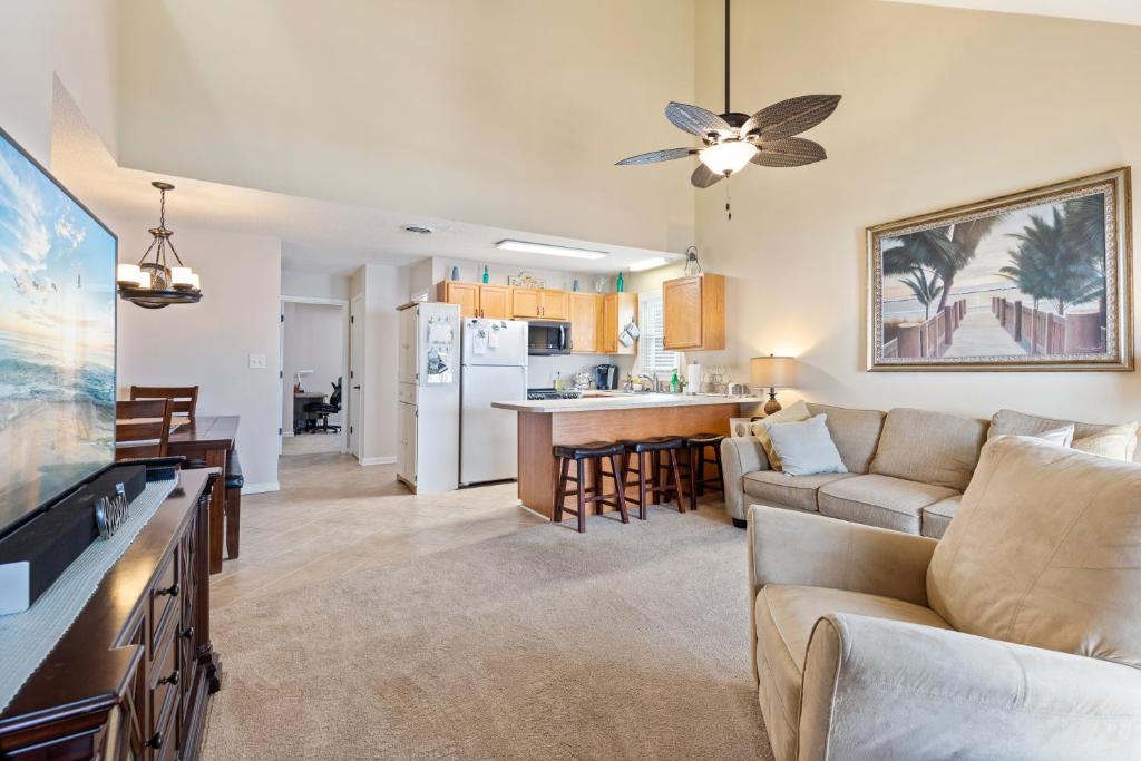 a living room with a couch and a kitchen at Sand Dunes Delight in Myrtle Beach