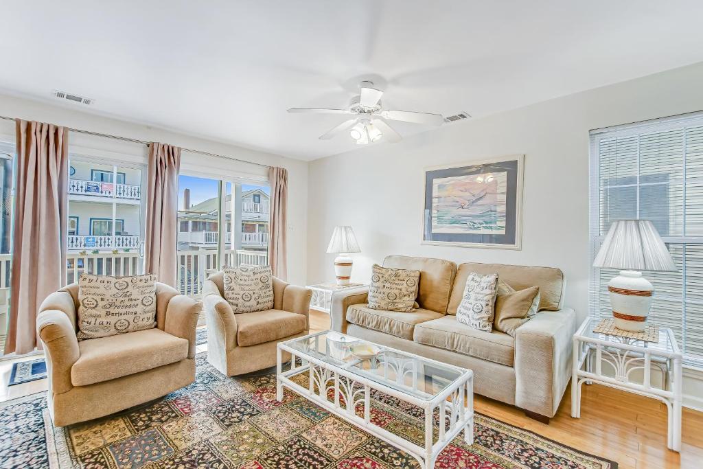 a living room with a couch and two chairs and a table at South Beach Views in Tybee Island