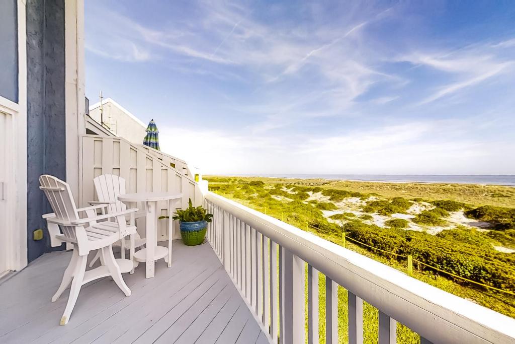 a balcony with a table and chairs and the ocean at Sandpiper 95096 in Fernandina Beach
