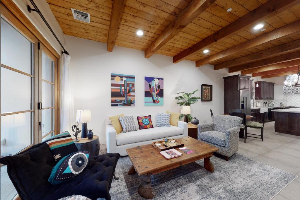a living room with a couch and a table at Menlo Magic in Tucson