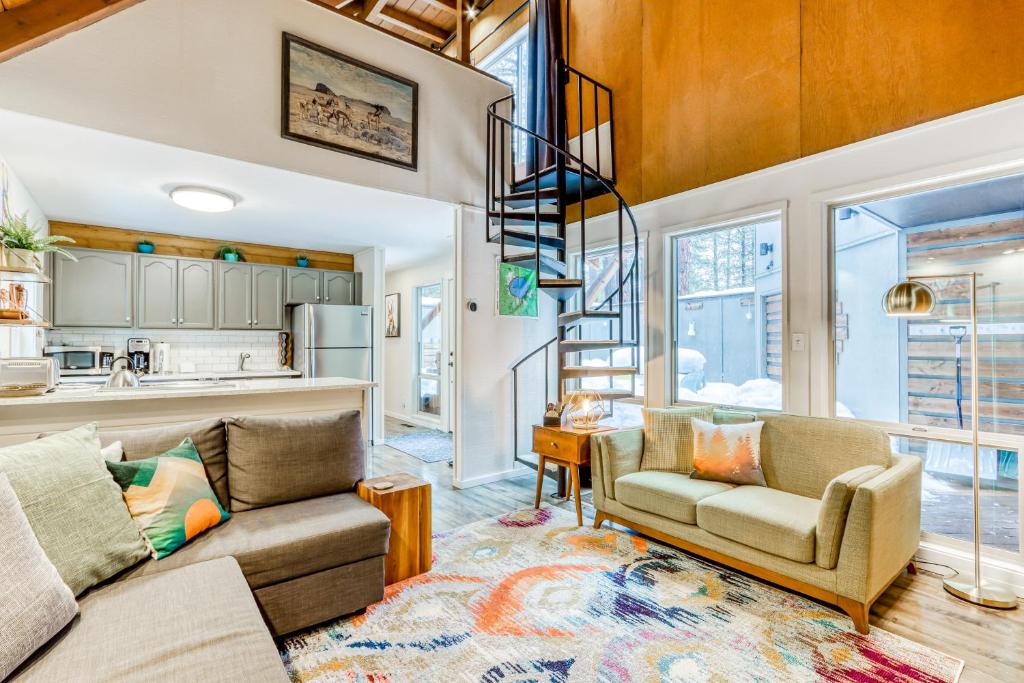 a living room with a couch and a spiral staircase at 18 Antelope in Sunriver
