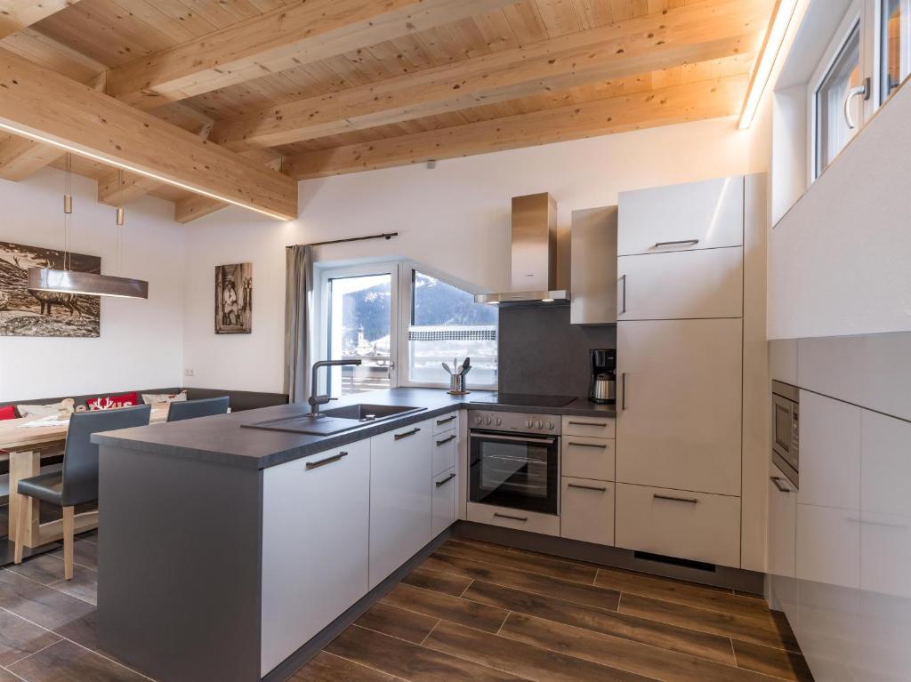a kitchen with white cabinets and a counter top at Dani&#39;s Ferienwohnung in Söll