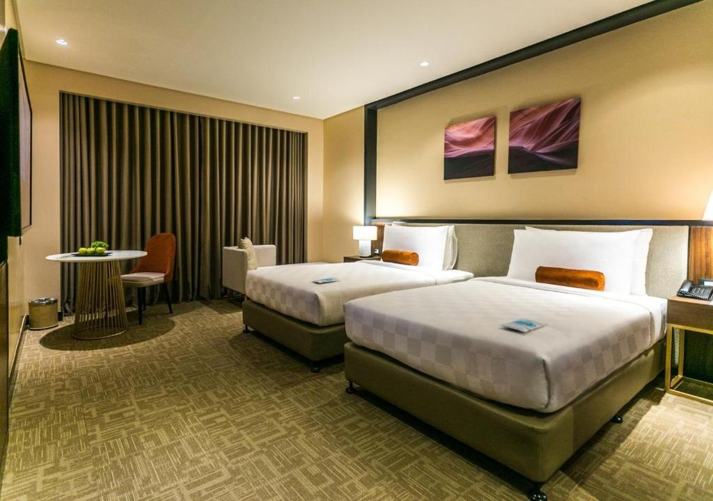 Postel nebo postele na pokoji v ubytování Grand Summit Hotel General Santos