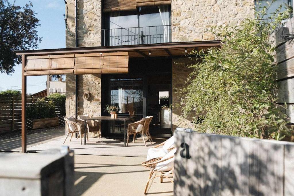 a house with a patio with a table and chairs at Casa Diana A in Girona