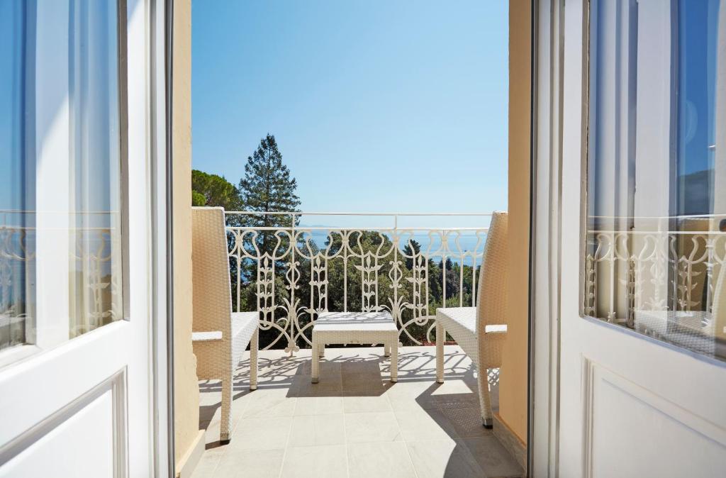 a balcony with a view of the ocean from a building at BRISTOL Hotel Opatija in Opatija