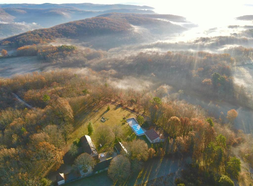 an aerial view of a house in the middle of a forest at Gîtes Sibémol in Simeyrols