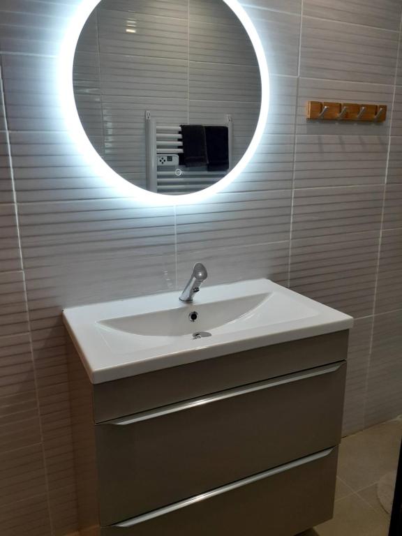 a bathroom with a sink and a mirror at Concarneau studio avec terrasse in Concarneau